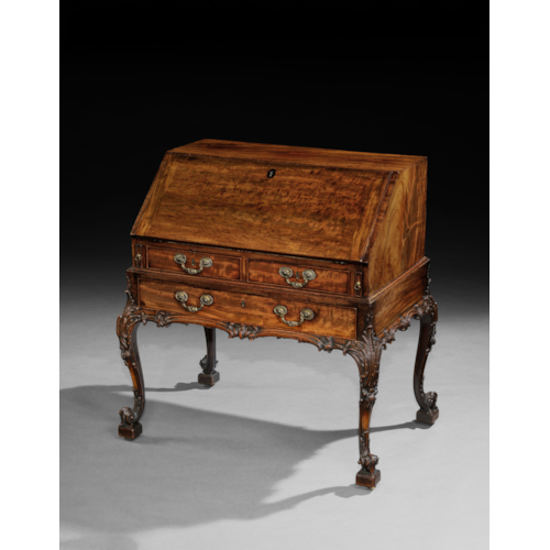 AN EXCEPTIONAL GEORGE III PERIOD CARVED MAHOGANY BUREAU ON STAND